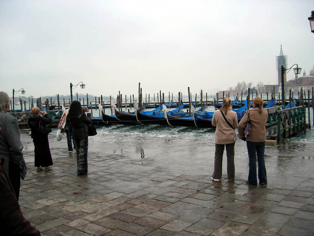 Gondolas docked near Piazza San Marco, with waterline lapping at sidewalk!