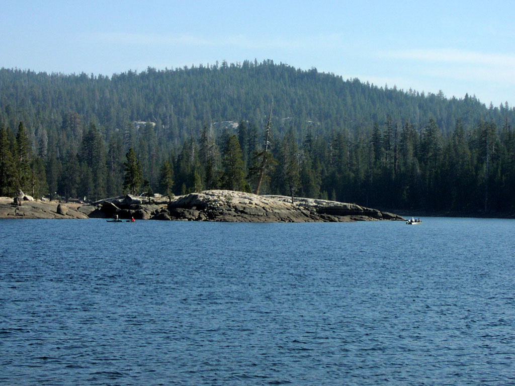 People boating near a small peninsula formation