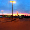 San Jose - Panorama of dawn helping low pressure sodium lamps light up a parking lot