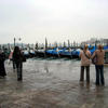 Gondolas docked near Piazza San Marco, with waterline lapping at sidewalk!