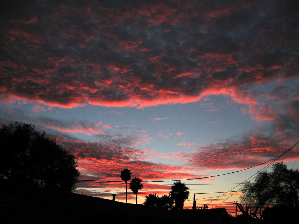 San Jose - The clouds reach a spectacular, fiery red color as night starts to take over